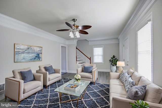 living room featuring ceiling fan, hardwood / wood-style flooring, and crown molding