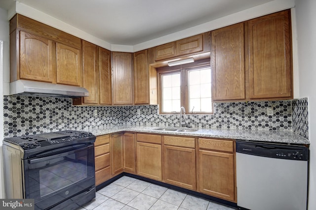 kitchen with dishwasher, light tile patterned floors, tasteful backsplash, black range oven, and sink