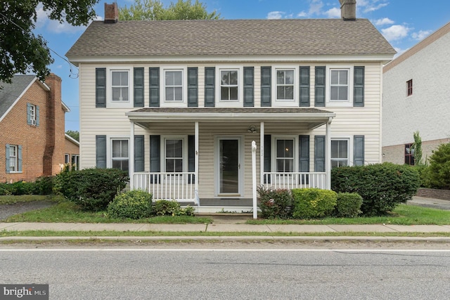 colonial house featuring covered porch