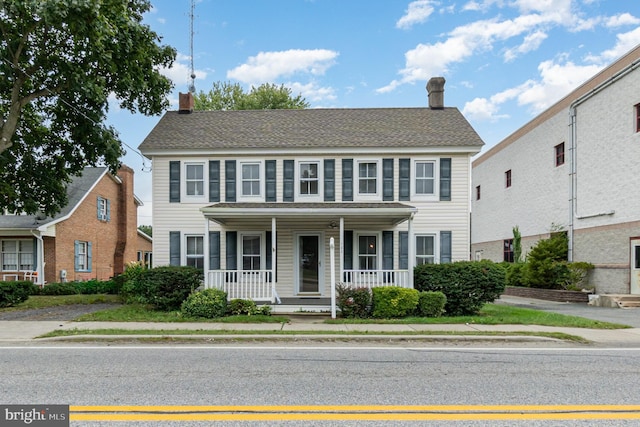 colonial-style house featuring a porch