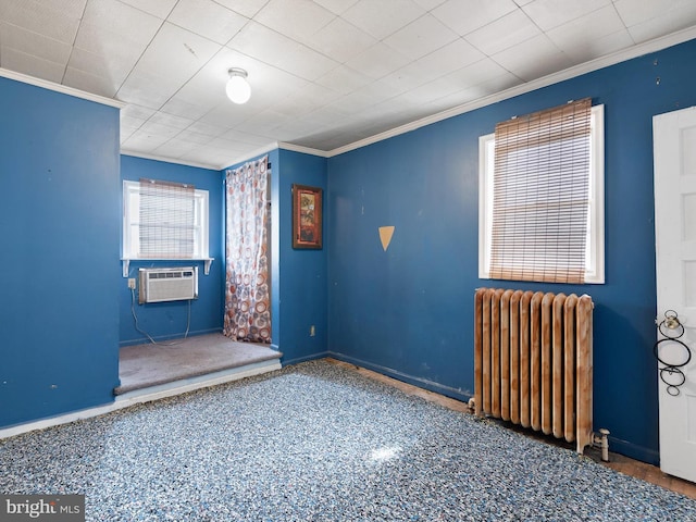 spare room featuring ornamental molding and radiator