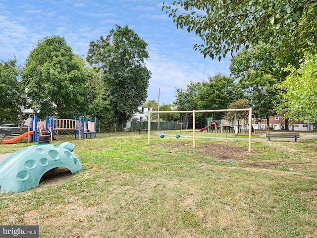 view of property's community with a yard and a playground