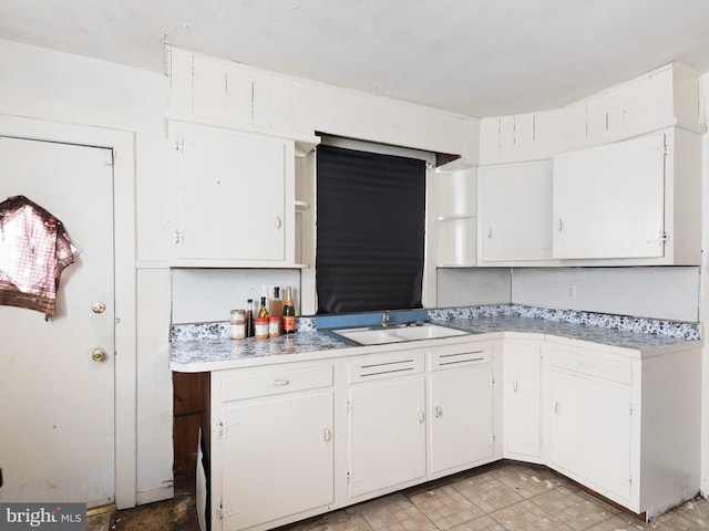 kitchen with white cabinetry and sink