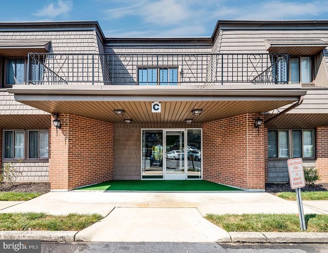 exterior space featuring a balcony and a porch