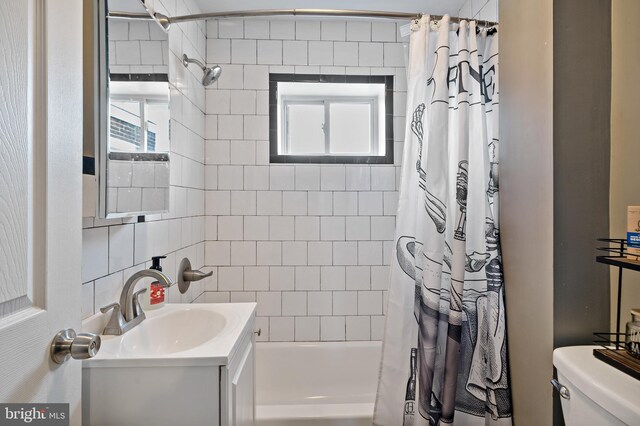 full bathroom with shower / bathtub combination with curtain, vanity, and toilet