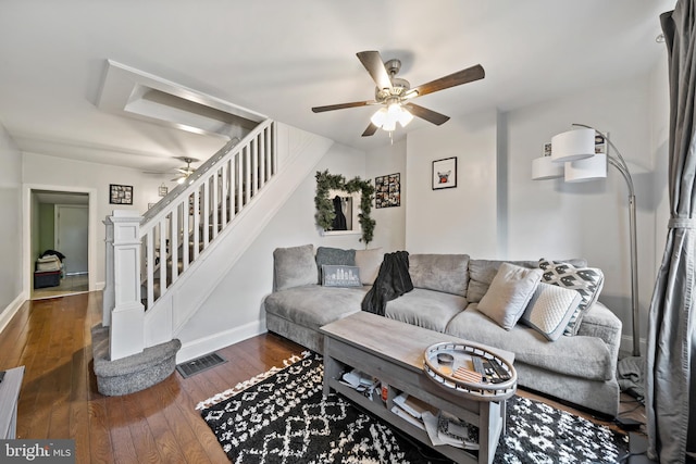 living room with ceiling fan and dark hardwood / wood-style flooring