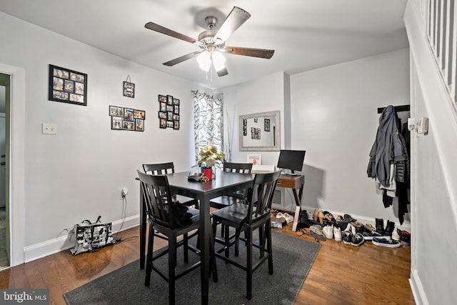 dining area featuring ceiling fan and dark hardwood / wood-style floors