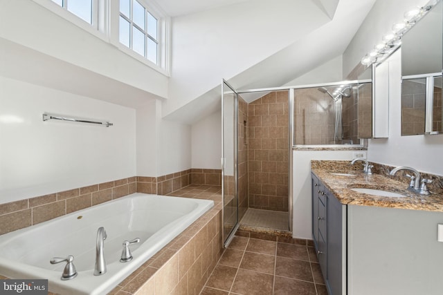 bathroom featuring tile patterned floors, shower with separate bathtub, and vanity