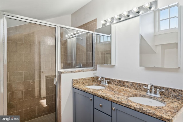 bathroom featuring vanity and a shower with door