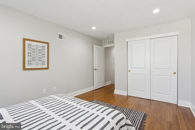 bedroom featuring wood-type flooring and a closet