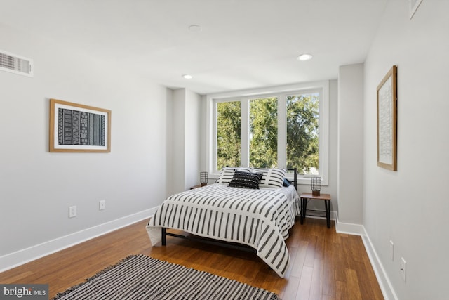 bedroom with dark hardwood / wood-style floors