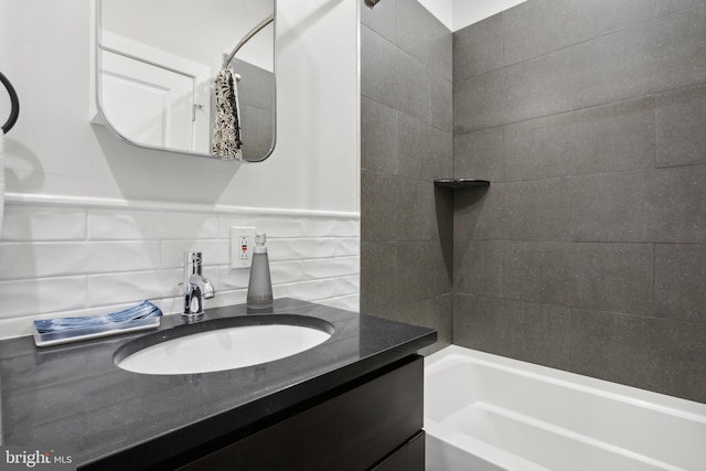 bathroom with tile walls, vanity, and shower / bath combo with shower curtain