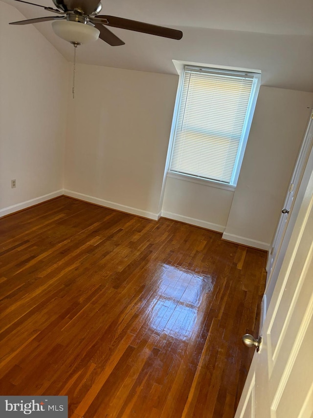 empty room featuring dark wood-type flooring and ceiling fan