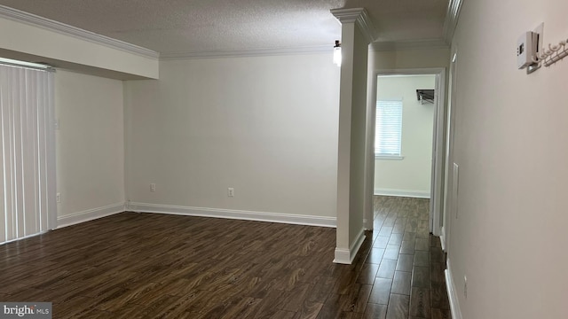 spare room with a textured ceiling, dark hardwood / wood-style floors, and ornamental molding