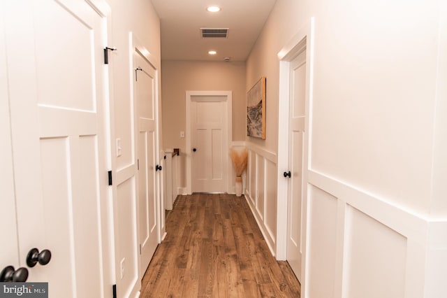 hallway with dark hardwood / wood-style flooring