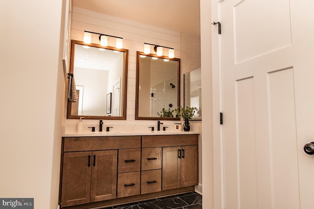 bathroom with a shower with door and vanity