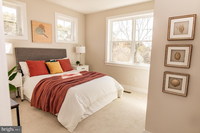 bedroom with light colored carpet