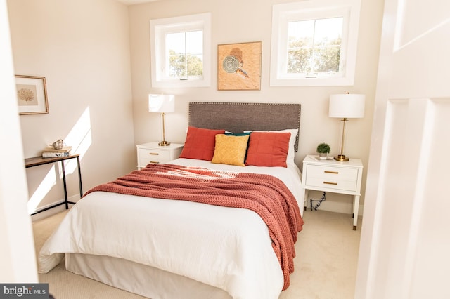 bedroom featuring light carpet