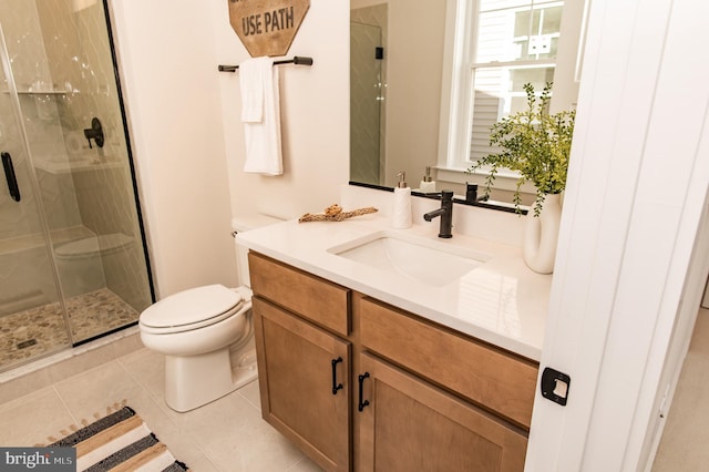 bathroom featuring vanity, toilet, walk in shower, and tile patterned flooring