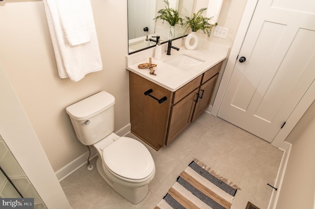 bathroom featuring tile patterned flooring, vanity, and toilet