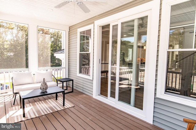 sunroom / solarium featuring ceiling fan