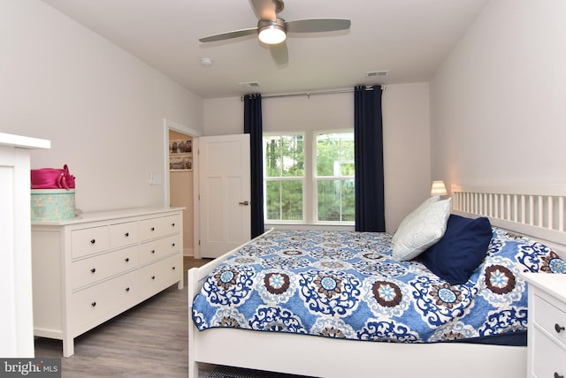 bedroom with hardwood / wood-style floors and ceiling fan