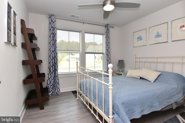 bedroom with ceiling fan and wood-type flooring