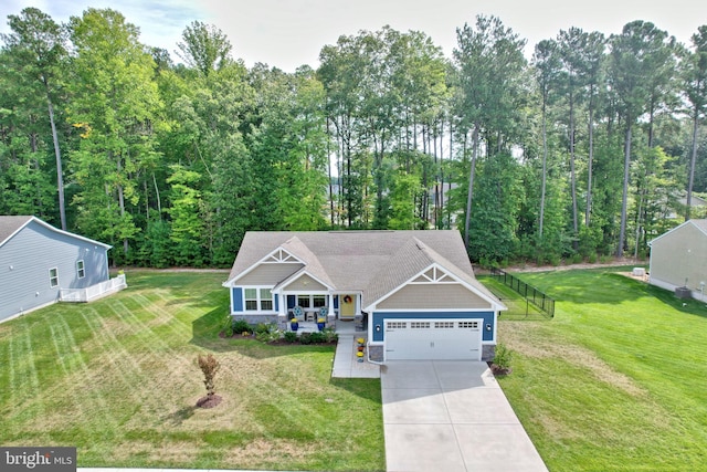 craftsman-style house featuring a garage and a front lawn