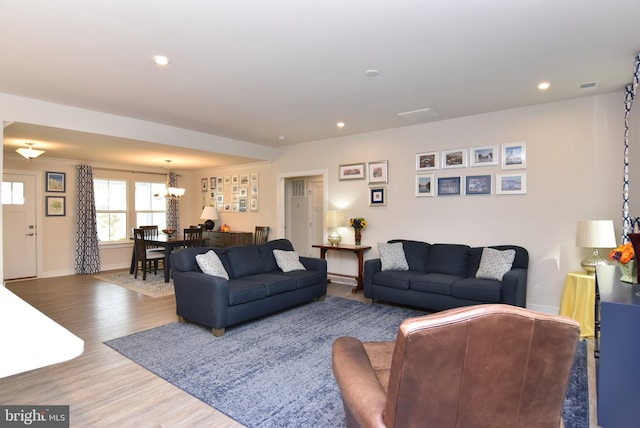 living room featuring a notable chandelier and hardwood / wood-style floors