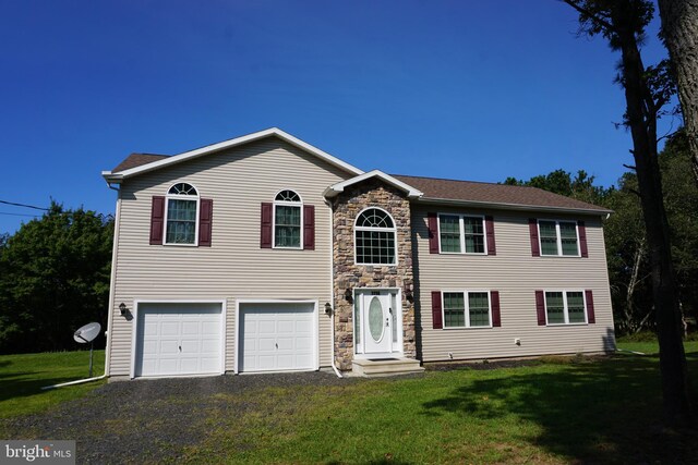 view of front facade with a front yard and a garage