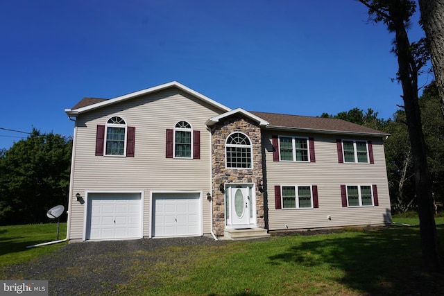 view of front of property with a garage, stone siding, driveway, and a front yard