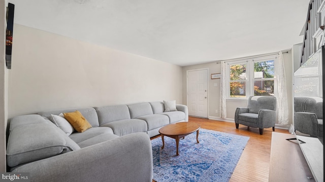 living room featuring light wood-type flooring and baseboards