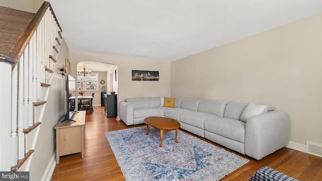 living room with hardwood / wood-style floors and a chandelier