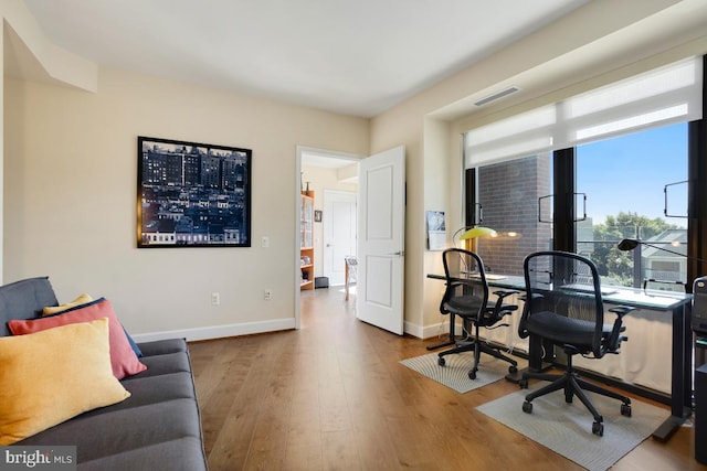 office space with light wood-type flooring