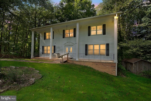 exterior space featuring a lawn and covered porch