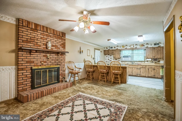 interior space with ceiling fan, a fireplace, and a textured ceiling