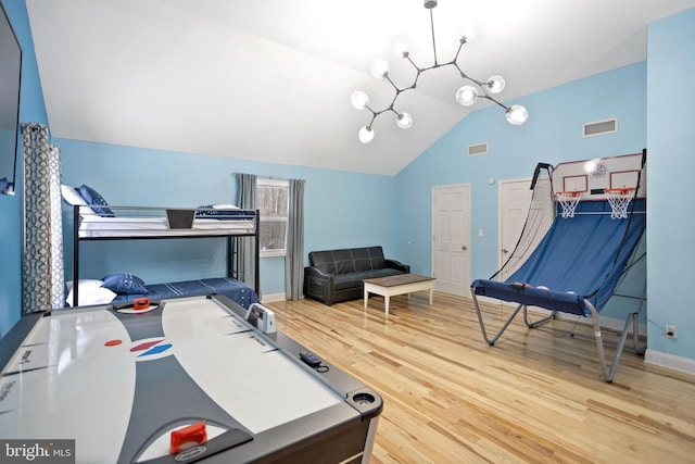 bedroom featuring hardwood / wood-style flooring and vaulted ceiling