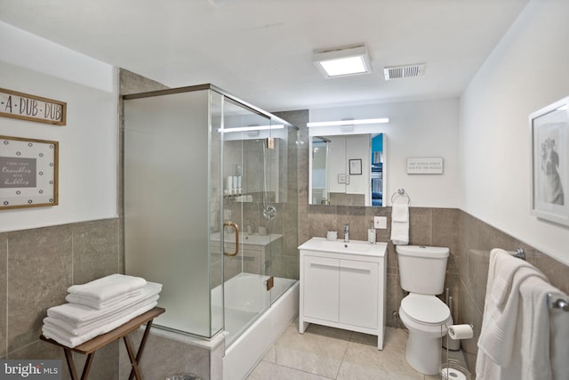 full bathroom with independent shower and bath, toilet, vanity, and tile walls