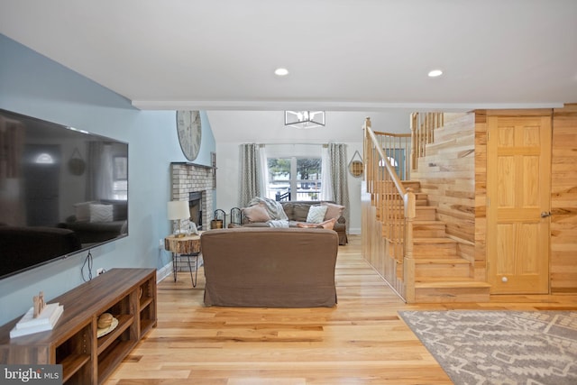 living room featuring wood-type flooring and a fireplace