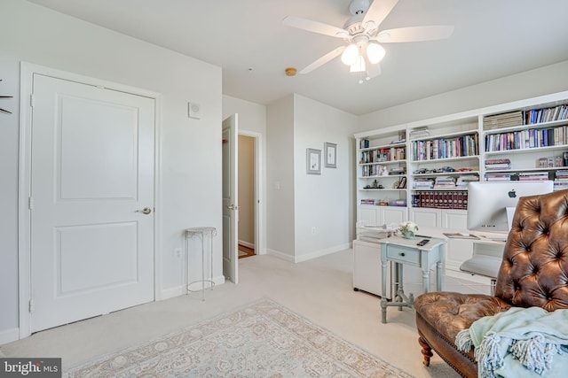 sitting room with baseboards, carpet floors, and ceiling fan