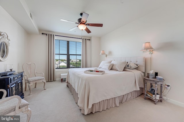 bedroom with light carpet, a ceiling fan, and baseboards