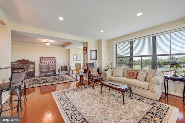 living area with hardwood / wood-style floors, recessed lighting, and baseboards