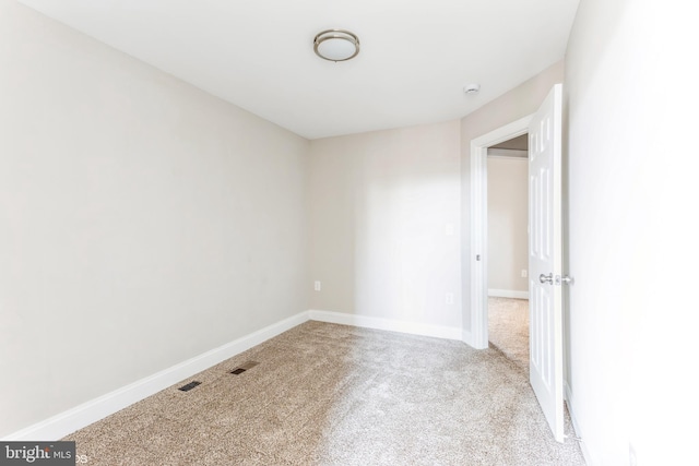 empty room featuring light carpet