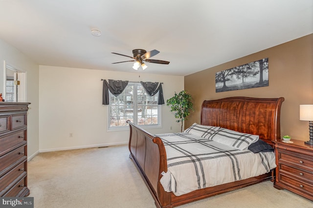 bedroom with ceiling fan and light carpet