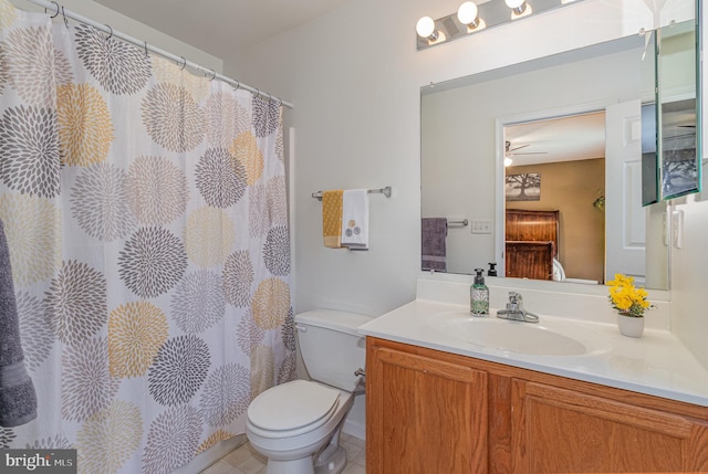 bathroom featuring tile patterned flooring, vanity, toilet, and ceiling fan