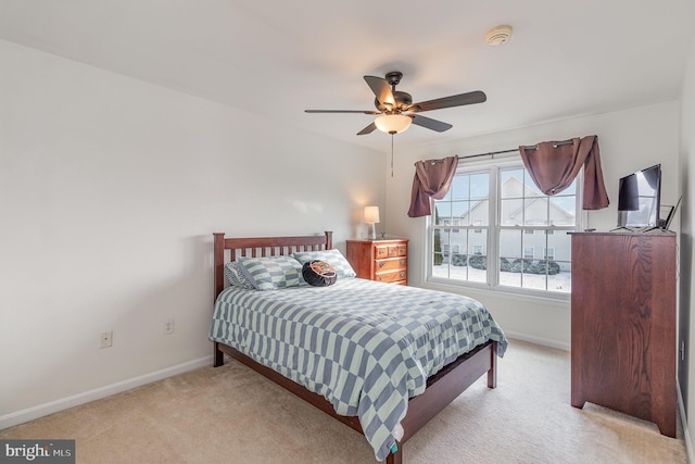 bedroom featuring ceiling fan and light carpet