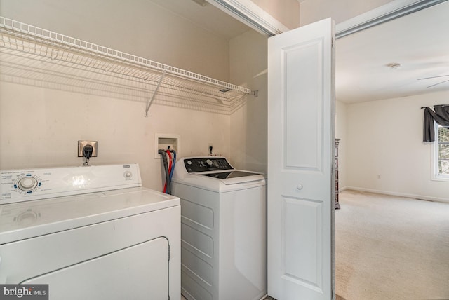 washroom with washer and dryer and light colored carpet