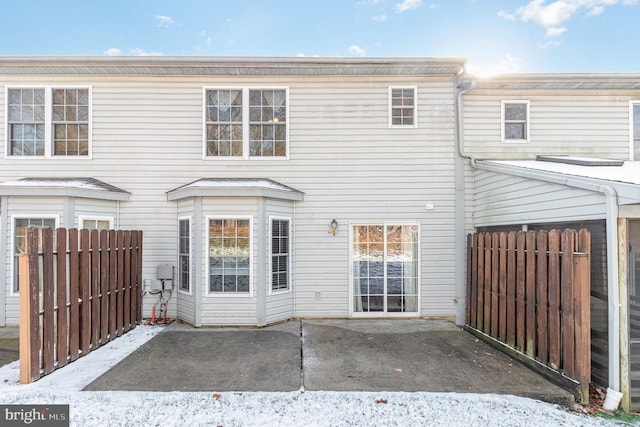 snow covered property featuring a patio area