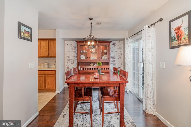 dining room featuring wood-type flooring and a notable chandelier