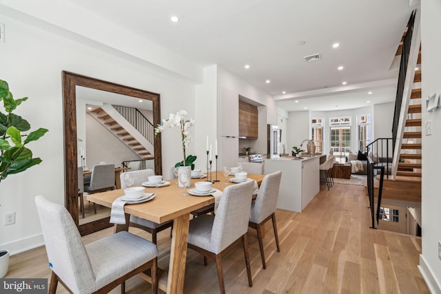 dining area featuring sink and light hardwood / wood-style floors